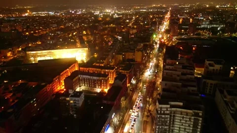 Beautiful skyline nightscape drone view over the illuminated city streets with Stock Footage 302523966