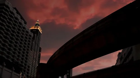 Beautiful skyscraper, sky train passing and clouds at sunset Stock Footage 5374144