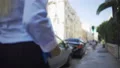 Beautiful slender blonde confidently walking along road, looking for her car 4k or 4k+ Resolution