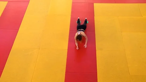 A beautiful, slender girl does exercises with sliding discs in the gym. Stock Footage 123551053