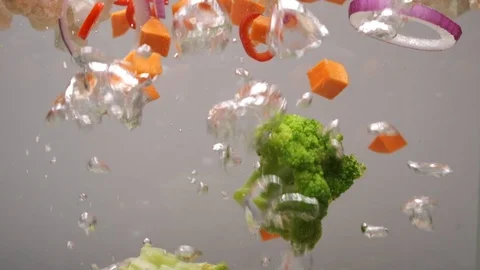 Beautiful sliced vegetables are cooked in boiling water. The view from the side Stock Footage 124307477