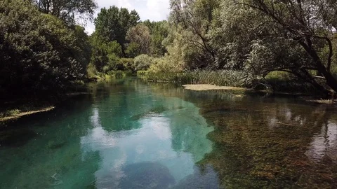 Beautiful slow drone flight above a crystal clear Tirino river in the Stock Footage 113345482