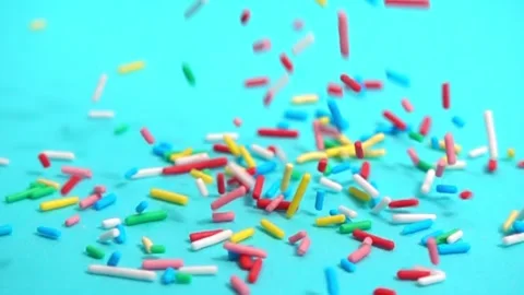 Beautiful slow fall of bright sprinkles against tranquil blue backdrop, cre.. Stock Footage 330986266