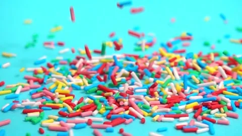 Beautiful slow fall of bright sprinkles against tranquil blue backdrop, cre.. Stock Footage 330987002