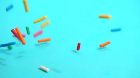 Beautiful slow fall of bright sprinkles against tranquil blue backdrop, cre.. Stock Footage 331228975