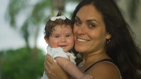 Beautiful slow motion of mom and baby looking at camera and smiling Stock Footage 113036633