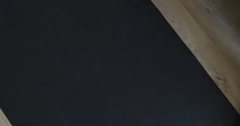 Beautiful slow motion shot of two hands lifting 2 weights resting on an Stock Footage 280219555