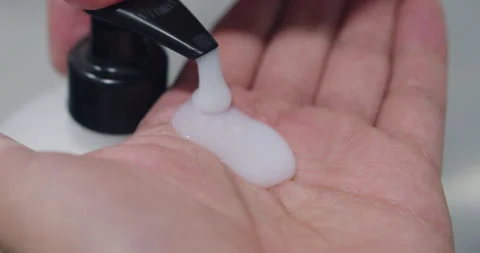 Beautiful slow motion shot of a young man's hands pulling liquid soap from Stock Footage 280127117