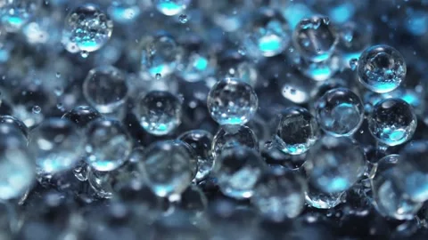 Beautiful slow motion of spheres bouncing and water splashing Stock Footage 165061413