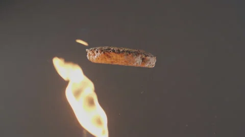 Beautiful slow-motion in the studio with flying beef patty for burger Stock Footage 97457443