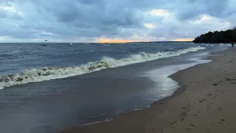 Beautiful slow motion view of blue grey sea waves rolling on sand beach in Stock Footage 253671781