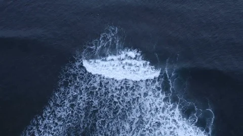 Beautiful slow-motion waves breaks as surfers watch, top down view Stock Footage 112702536