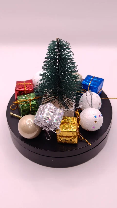 Beautiful small Christmas tree on a stand with decorations close up Stock Footage 323960892