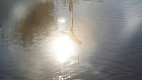 Beautiful small river and bungee jump rope on a tree in Sunlight reflections Stock Footage 104956767