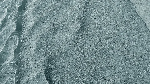 Beautiful small sea waves clean transparent water on sandy beach of sea shore Stock Footage 306072137