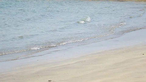 Beautiful small sea waves on a sandy beach Stock Footage 128497567