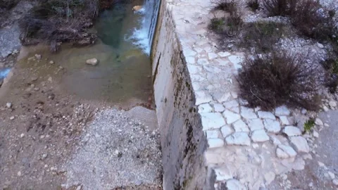 Beautiful Small Waterfall Creating a Pond in a Rocky River Stock Footage 305234936