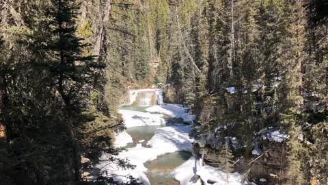 Beautiful Small Waterfall in the Distance in the Spring - River Melting Video stock 129128256