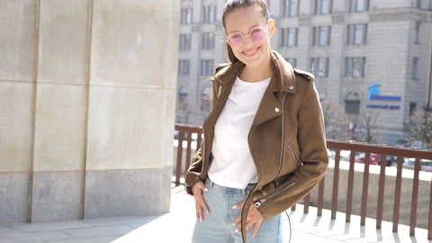 Beautiful smiling brunette model dressed in summer hipster jacket Stock Footage 140994941