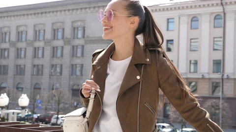 Beautiful smiling brunette model dressed in summer hipster jacket Stock Footage 140995590