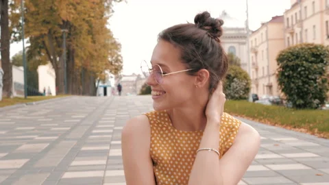 Beautiful smiling brunette model dressed in summer hipster yellow dress Stock Footage 141817230