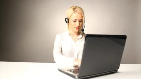 Beautiful smiling call center operator talking to business Stock Footage 10585257