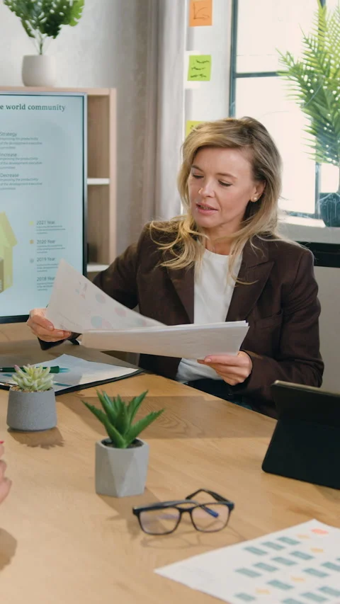 Beautiful smiling high-skilled multiethnic female business team sharing ideas in Stock Footage 325035937