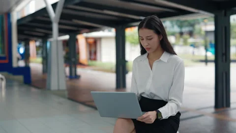 Beautiful Smiling It Worker Seated And Writing Code on her Laptop Sitting Stock Footage 303634805