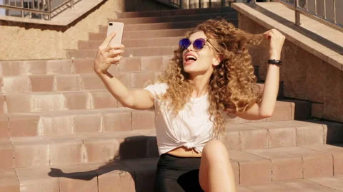 Beautiful smiling model with afro curls taking selfie Stock Footage 146053578