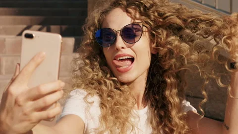 Beautiful smiling model with afro curls taking selfie Stock Footage 146053625