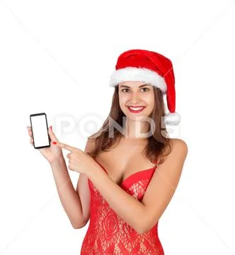 Beautiful smiling young girl in christmas hat and swimsuit presenting mobile Stock Photos
