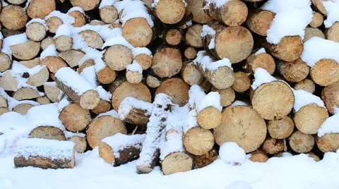 Beautiful snow falling gently on background of wooden logs Stock Footage 50543112