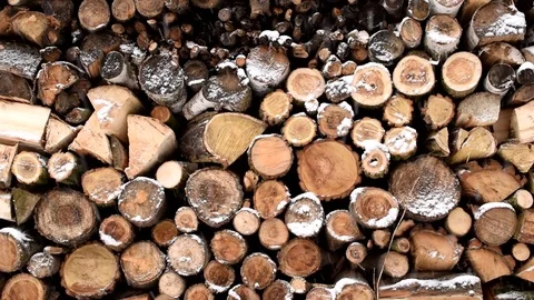 Beautiful snow falling in slow motion on background of firewood Stock Footage 82966017