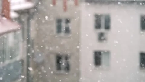 Beautiful snowflakes gently falling softly over an urban landscape, creating a Stock Footage 306158165