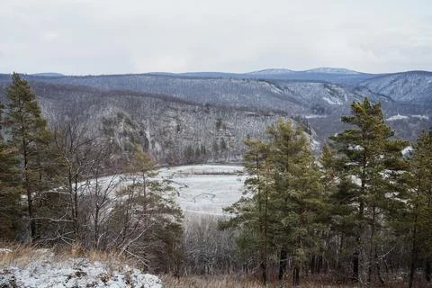 A beautiful snowy landscape features an array of trees dotted throughout, w.. Stock Photos