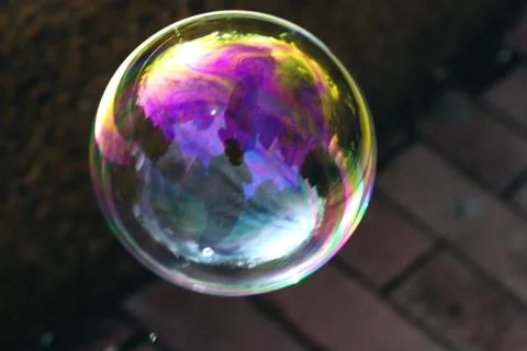 A beautiful soap bubble with reflections and overflows. Stock Photos