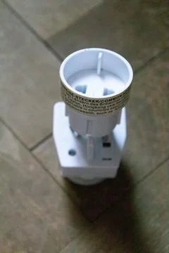 Beautiful socket plug adapters isolated on wood background Stock Photos