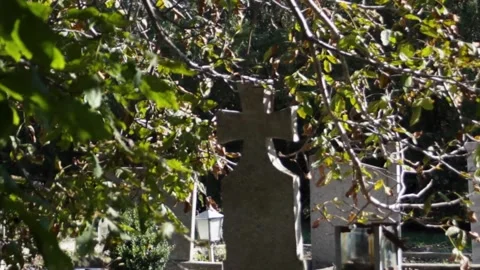 A beautiful solid headstone in the form of a cross on a grave in a cemetery in a Stock Footage 297461325