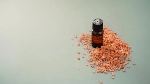 Beautiful spa composition with vial and sea salt for bath Stock Photos