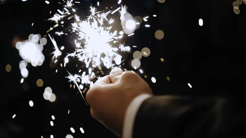 A beautiful sparkler is burning in the man's hand Stock Footage 166520162
