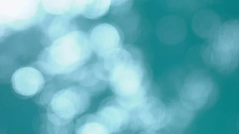 Beautiful sparkling shiny texture of blurry blue water with sun reflected on Stock Footage 135516627