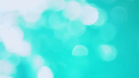 Beautiful sparkling shiny texture of blurry blue water with sun reflected on Stock Footage 135550982