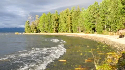 Beautiful sparkling waves roll onto the beach of lake. Stock Footage 285380897