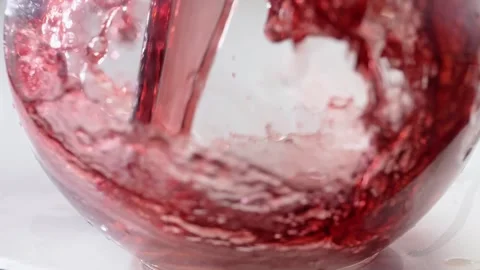 Beautiful splash and wave of red wine or berry juice in a glass goblet Stock Footage 268745255
