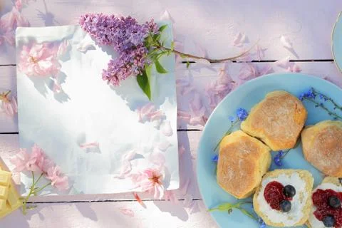 Beautiful, spring breakfast background with Scottish scones, lilac  and cherr Stock Photos