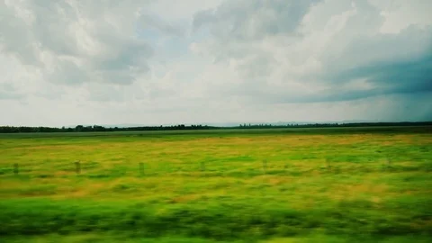 Beautiful spring landscape from the car window. Agricultural land and fields in Stock Footage 77023407