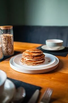 Beautiful Stack of Pancakes on a White Plate Standing on a Wooden Breakfast.. Stock Photos
