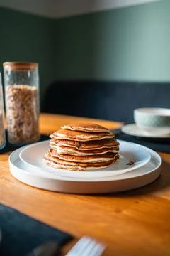 Beautiful Stack of Pancakes on a White Plate Standing on a Wooden Breakfast.. Stock Photos