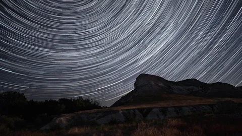 Beautiful star trails time-lapse over the hills. 動画素材 84883228