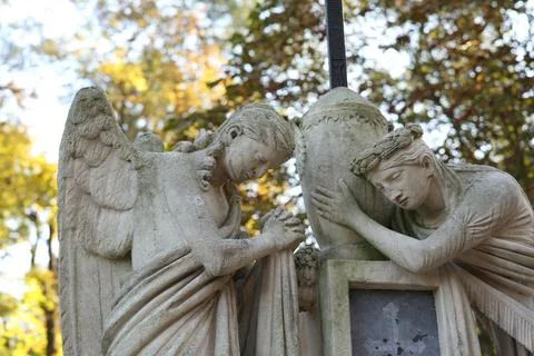 Beautiful statues of angels at cemetery. Religious symbol Stock Photos